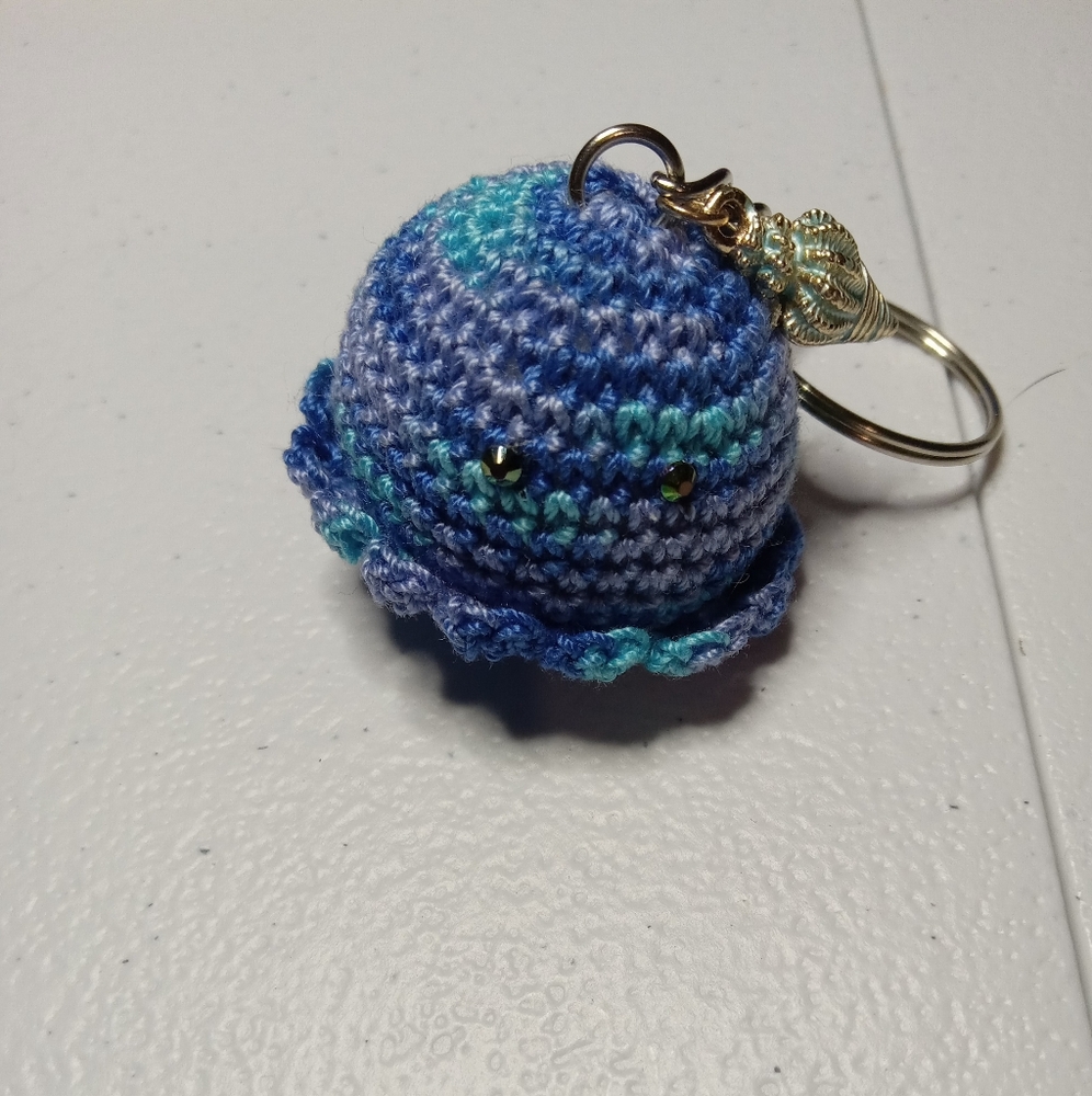 Handmade baby octopus keychain with seashell charm.